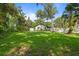 Sprawling backyard with lush green grass and mature trees offering shade and privacy at 650 Main St, Altamonte Springs, FL 32701