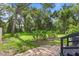 Lush backyard with a brick patio, mature trees, and serene greenery for relaxation at 650 Main St, Altamonte Springs, FL 32701