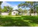 Beautifully landscaped backyard featuring lush green grass and mature trees at 650 Main St, Altamonte Springs, FL 32701