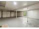 Unfinished basement featuring concrete floor and walls, with garage door and ample storage space at 650 Main St, Altamonte Springs, FL 32701