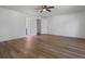Spacious bedroom with neutral walls, modern ceiling fan, and wood-look flooring at 650 Main St, Altamonte Springs, FL 32701
