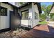 Back exterior view of home featuring painted brick, wooden deck, and an updated electrical panel at 650 Main St, Altamonte Springs, FL 32701