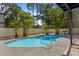 Backyard featuring a refreshing in-ground swimming pool and surrounding tropical landscaping at 650 Main St, Altamonte Springs, FL 32701