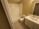 Bathroom with a white tiled shower-tub combo and a vanity with countertop at 709 Orchid Dr, Davenport, FL 33897