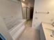 Bathroom with a garden tub, glass-enclosed shower, and a vanity with sink at 709 Orchid Dr, Davenport, FL 33897