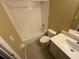 Bathroom featuring a white tiled shower-tub, toilet, and vanity with sink at 709 Orchid Dr, Davenport, FL 33897