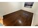 Bedroom featuring wood flooring, white walls, and a window for natural light at 709 Orchid Dr, Davenport, FL 33897