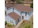 Charming two-story home with light blue siding, brown roof, and well-manicured lawn and foundation plantings at 709 Orchid Dr, Davenport, FL 33897
