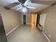 View of the living room with tile flooring, a ceiling fan, and a window at 709 Orchid Dr, Davenport, FL 33897