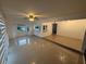Open-concept living room has tile flooring, and a ceiling fan at 709 Orchid Dr, Davenport, FL 33897