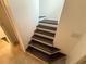 Stairway featuring wooden steps and neutral-colored walls leading to the upper level at 709 Orchid Dr, Davenport, FL 33897