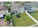 Aerial view of a spacious backyard with a lush green lawn, surrounded by a white privacy fence at 721 Hardwood Cir, Orlando, FL 32828