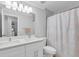 Bathroom featuring a double vanity with white countertops and a shower behind a curtain at 721 Hardwood Cir, Orlando, FL 32828