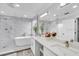 Bright bathroom featuring double sinks with marble countertops, a soaking tub and a separate glass-enclosed shower at 721 Hardwood Cir, Orlando, FL 32828