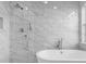 Bright bathroom featuring a marble tiled glass shower with dual shower heads and a soaking tub at 721 Hardwood Cir, Orlando, FL 32828