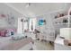 Cozy bedroom featuring both a full sized bed and a crib, plus bright sunny windows at 721 Hardwood Cir, Orlando, FL 32828