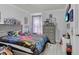 Bedroom with neutral walls and floors and a bed featuring a comforter with comic book characters on it at 721 Hardwood Cir, Orlando, FL 32828
