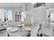 Bright dining room showcasing a glass-top table, white chairs, and elegant decor at 721 Hardwood Cir, Orlando, FL 32828