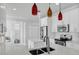 Bright and contemporary kitchen with stainless steel appliances and sleek pendant lighting at 721 Hardwood Cir, Orlando, FL 32828