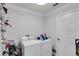 Laundry room featuring modern washer and dryer units, shelving, and storage space at 721 Hardwood Cir, Orlando, FL 32828