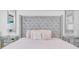 Airy bedroom featuring a grey upholstered headboard, mirrors and streaming sunlight at 721 Hardwood Cir, Orlando, FL 32828