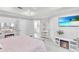 Airy bedroom featuring a decorative vanity, TV, and streaming sunlight at 721 Hardwood Cir, Orlando, FL 32828