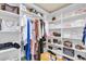 Spacious walk-in closet complete with ample shelving and hanging space for easy organization and storage at 721 Hardwood Cir, Orlando, FL 32828