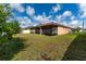 Exterior view of the back of the house, featuring a screened in porch and a green lawn at 802 Massy Ct, Kissimmee, FL 34759