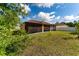 Exterior view of the back of the house, featuring a screened in porch and a green lawn at 802 Massy Ct, Kissimmee, FL 34759