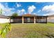 Exterior view of the back of the house, featuring a screened in porch and a green lawn at 802 Massy Ct, Kissimmee, FL 34759