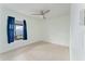 Bright bedroom with tile flooring, ceiling fan, and a window overlooking the backyard at 802 Massy Ct, Kissimmee, FL 34759