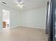 This bedroom features neutral paint, tile floors and an attached bathroom at 802 Massy Ct, Kissimmee, FL 34759