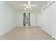 Bright bedroom featuring neutral paint, tile floors, a ceiling fan, window and large closet at 802 Massy Ct, Kissimmee, FL 34759