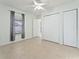 Bright bedroom featuring neutral paint, tile floors, a ceiling fan, window and large closet at 802 Massy Ct, Kissimmee, FL 34759