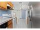 Kitchen view showcases white tile floors, stainless steel refrigerator, and white electric range at 802 Massy Ct, Kissimmee, FL 34759