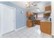 Well-lit kitchen featuring tile flooring, stainless steel refrigerator, and wooden cabinetry at 802 Massy Ct, Kissimmee, FL 34759