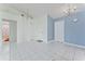 Clean, minimalist living space with tile floors, neutral walls, and bright lighting at 802 Massy Ct, Kissimmee, FL 34759