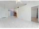 Open living area with tile flooring leads to a kitchen with wooden cabinets and stainless appliances at 802 Massy Ct, Kissimmee, FL 34759