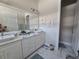Bright bathroom with double vanities, marble countertops, and ample storage space at 8270 Topsail Pl, Winter Garden, FL 34787