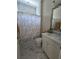 Bathroom featuring a white vanity, decorative mirror, and marble-style tile flooring at 8270 Topsail Pl, Winter Garden, FL 34787