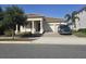 Beautiful single-story home with a columned porch, brick driveway, and two-car garage at 8270 Topsail Pl, Winter Garden, FL 34787