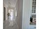 Inviting hallway with marble floors, pendant lights, and views of the front door and a decorative plant at 8270 Topsail Pl, Winter Garden, FL 34787