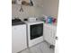 Functional laundry room with washer, dryer, white cabinets, and ample storage space at 8270 Topsail Pl, Winter Garden, FL 34787