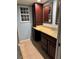 Bathroom features a vanity with storage, countertop, sink, mirror, and window at 878 Elgin Dr, Winter Springs, FL 32708