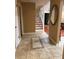 Inviting entryway featuring tile floors, staircase, and a decorative mirror at 878 Elgin Dr, Winter Springs, FL 32708