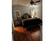 Spacious main bedroom featuring hardwood floors, ceiling fan and natural light from the window at 878 Elgin Dr, Winter Springs, FL 32708