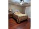 Cozy bedroom featuring hardwood floors, a comfortable bed, and a stylish nightstand at 878 Elgin Dr, Winter Springs, FL 32708