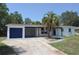 Charming single-story home with a blue garage door and a well-manicured front yard featuring a mature palm tree at 894 Superior St, Deltona, FL 32725