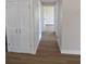 Hallway features updated wood floors, doors and neutral paint at 894 Superior St, Deltona, FL 32725