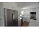 Spacious kitchen with stainless steel refrigerator and white cabinets at 894 Superior St, Deltona, FL 32725